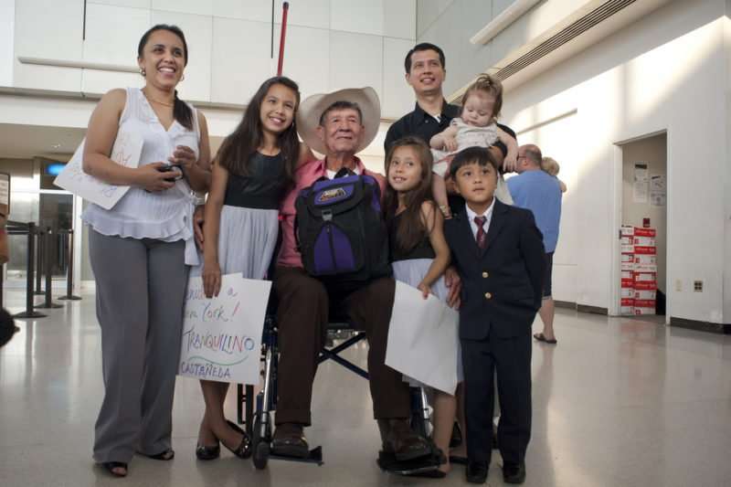 Oscar Ramirez and Nidia Franco pose for a family portrait with their children Andrea, 11, Nicole, 7, Oscar Jr, 5, Dulce, 9 months, and OScar's father Tranquilino Casteneda. Only a short while ago, no one in this photograph could have imagined that a family portrait would look like this. For the first time, Oscar Ramirez meets his father Tranquilino Castaneda, who travelled to New York from Guatemala on Monday. The two united years after a massacre in the village of Dos Erres killed Tranquilino's wife and eight of his nine children. Oscar, a three-year-old at the time, was taken from the village and raised by the family of an officer in the Guatemalan Army. Tranquilino believed that all nine of his children were killed until recently. Photo by Torsten Kjellstrand/2012